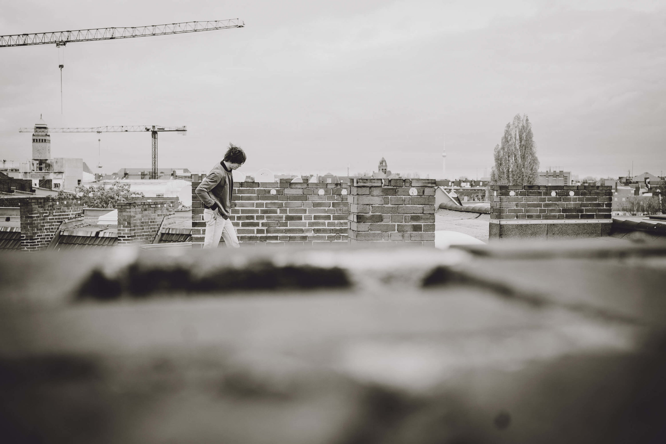 guitarist Simon Meyer walks on rooftop in Berlin-Neukölln